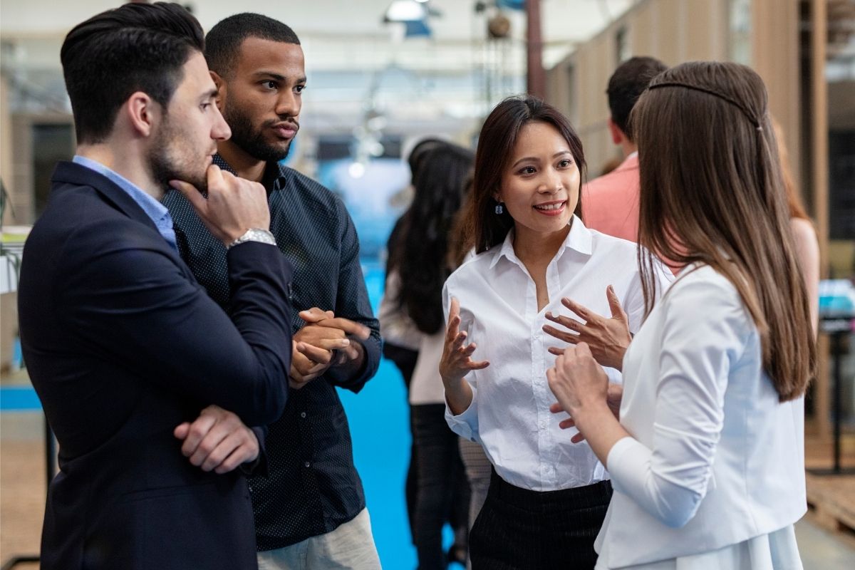 The picture shows a group of people networking.