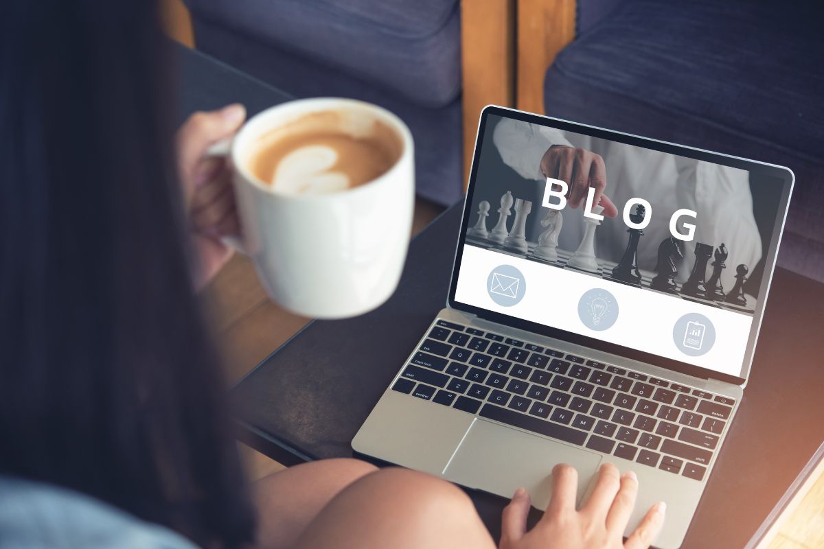 The picture shows a girl using a laptop while having a coffee referring to building a blog with affiliate marketing is a simple way to earn money online without working daily.