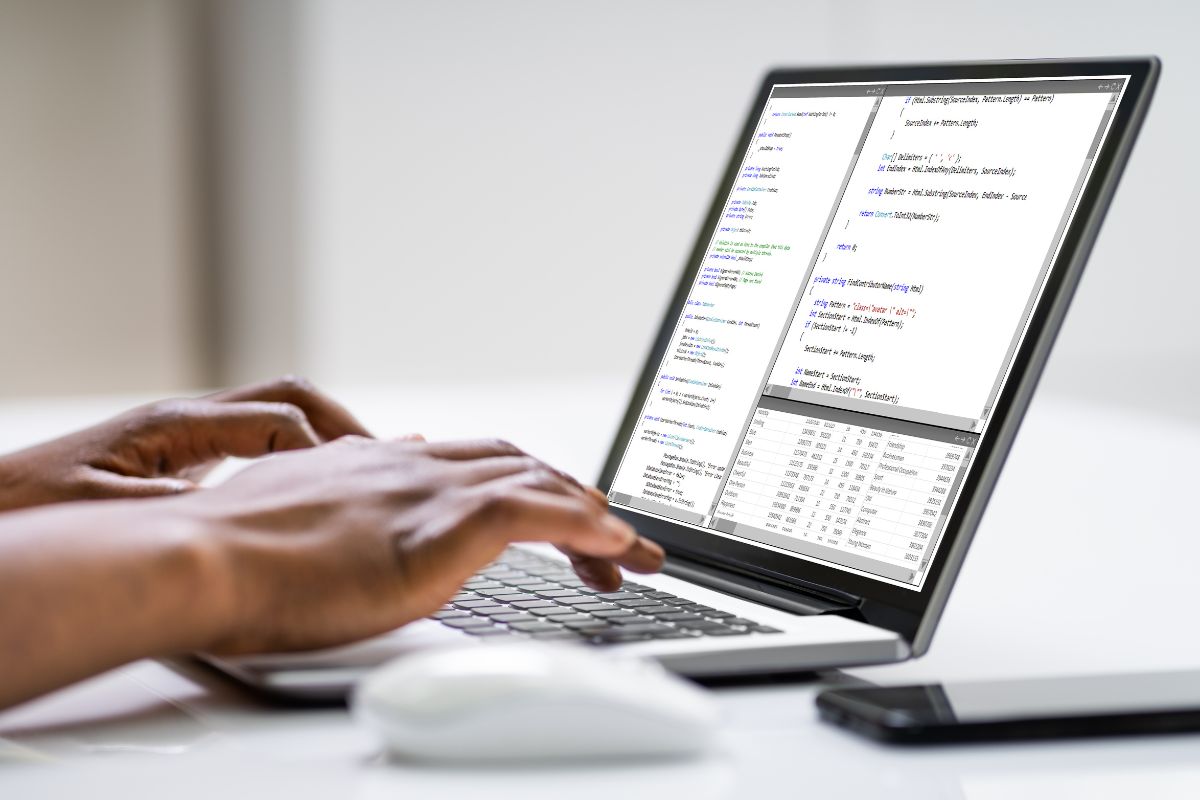 The picture shows a man's hand coding on a laptop which means that developing an app is one of the best ways to make money online long-term.