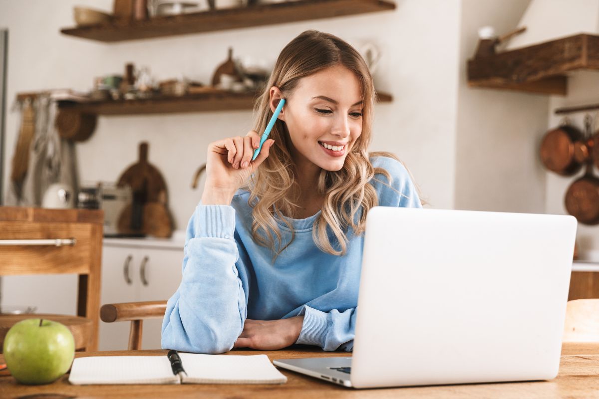 The picture tells about an apple, a notebook, and a girl using a laptop referring to developing and selling an online toolkit as a simple way to make money online.