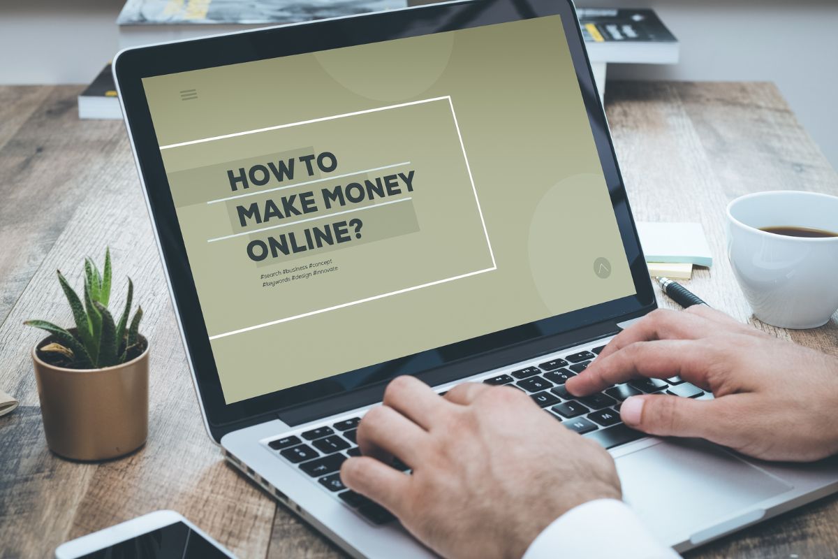 The photo shows a man's hand looking for a way to make money online.