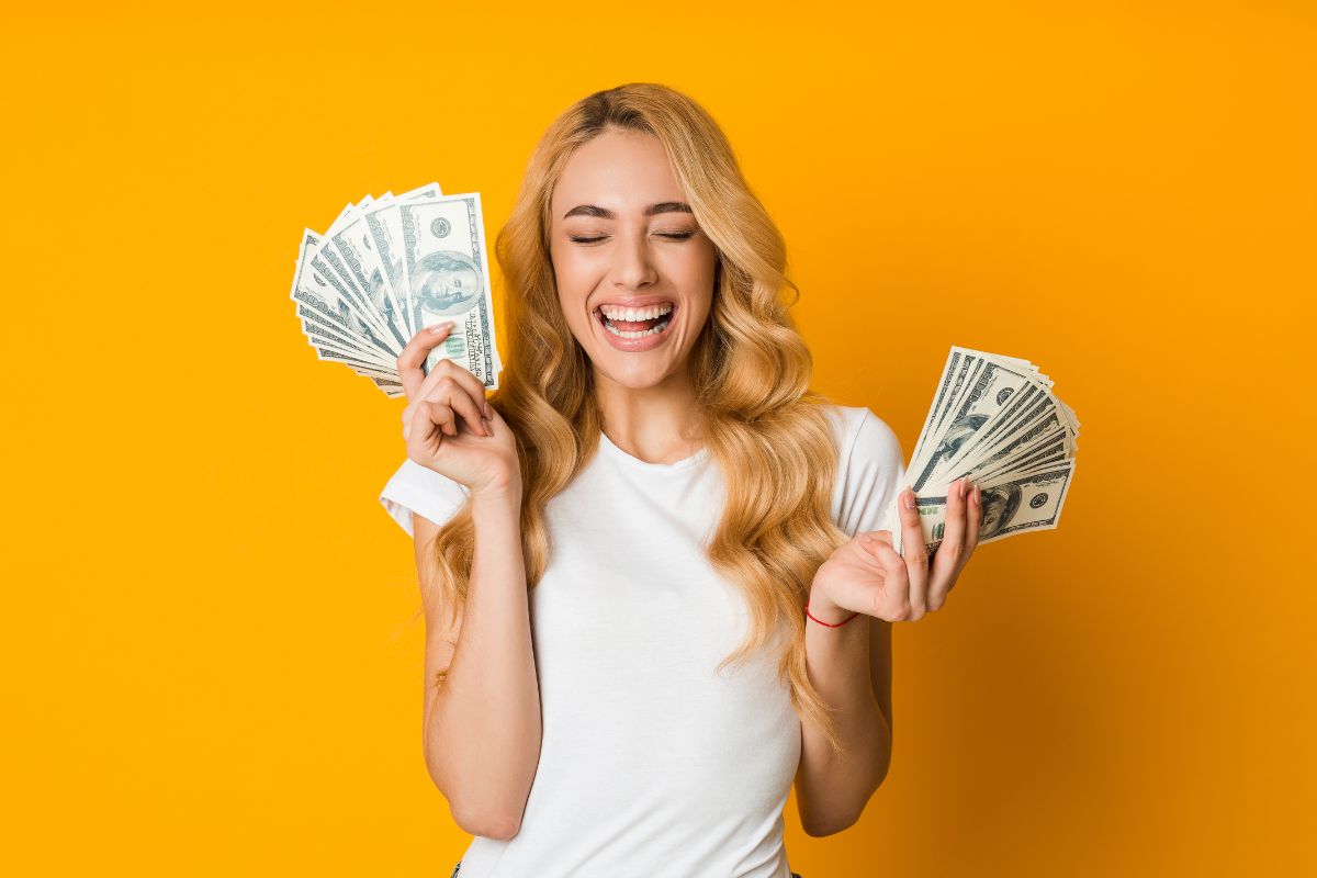 The photo tells about a girl holding money while being happy which refers to maintaining a positive attitude toward money helps reduce financial stress and build a strong financial habit.