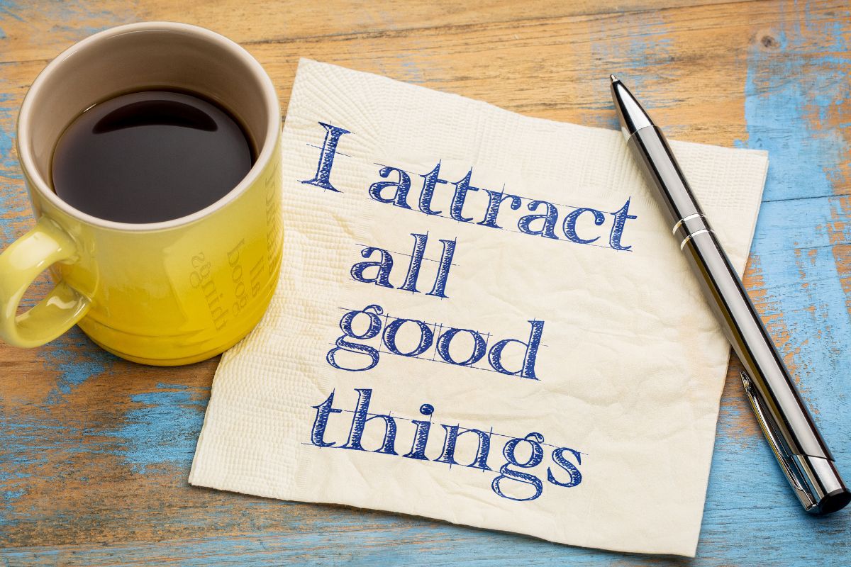 The photo of a coffee and a paper with an affirmation quote.
