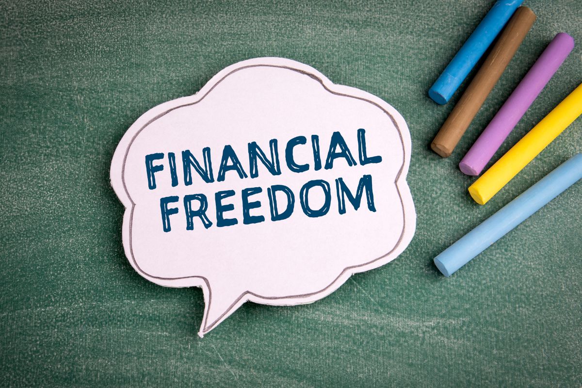 The photo tells about colored chalk and a cloud paper with notes which refers to learning the importance of financial freedom and starting your journey to a more abundant future.