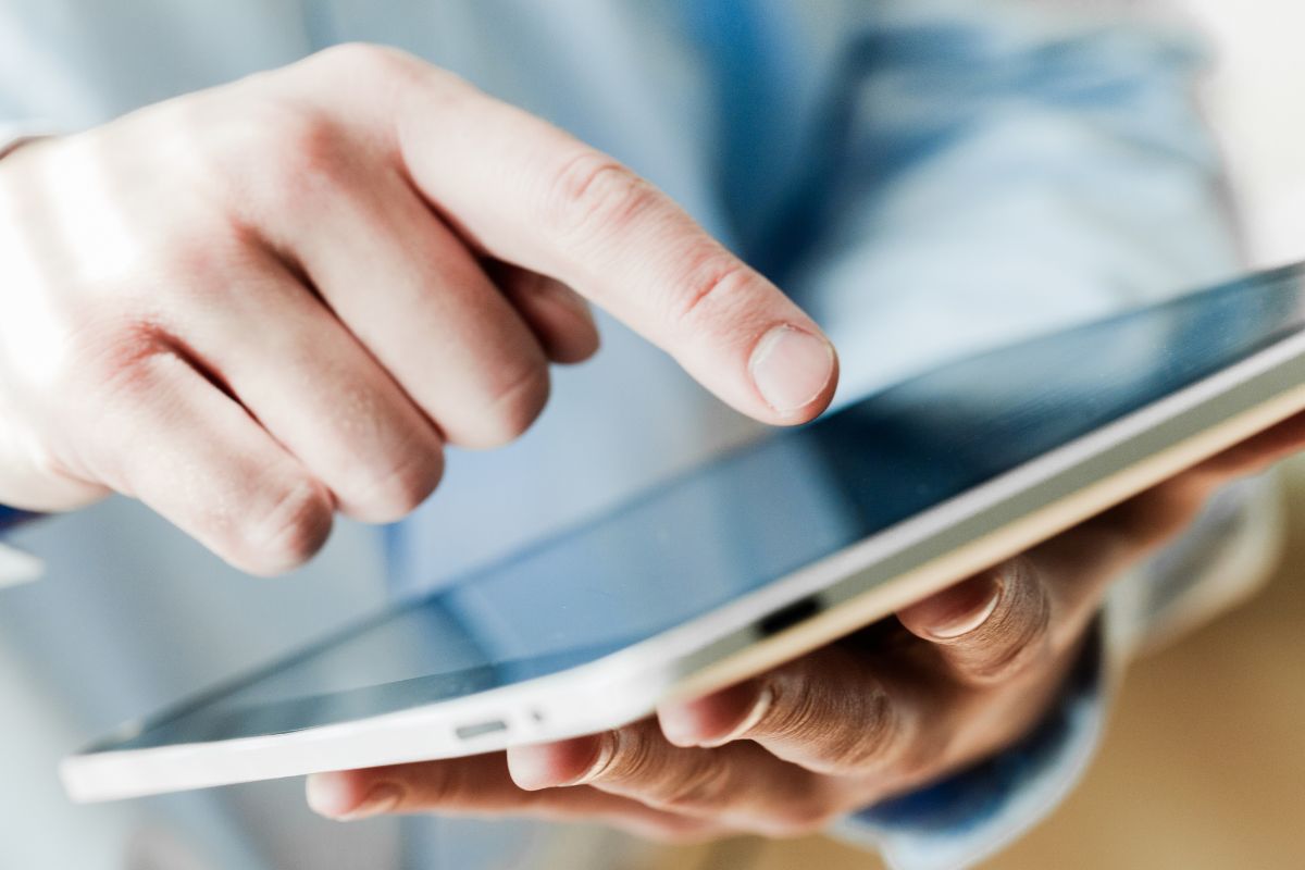 An image of a man's hand cancelling unused subscriptions.