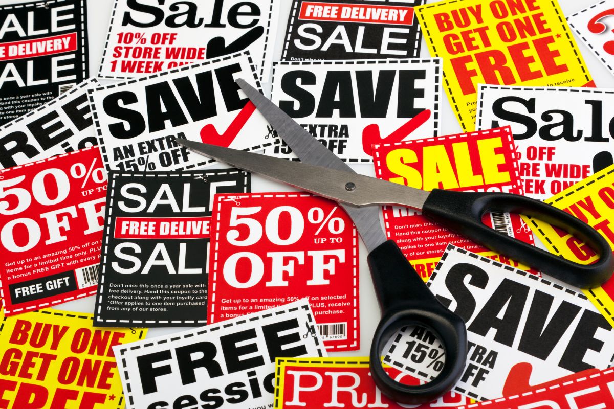 An image of a scissor and coupons.
