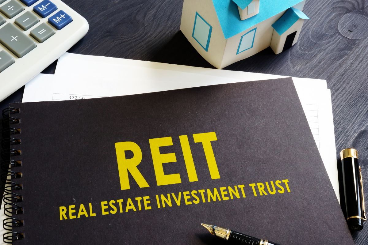 An image of a notebook with the REIT meaning.