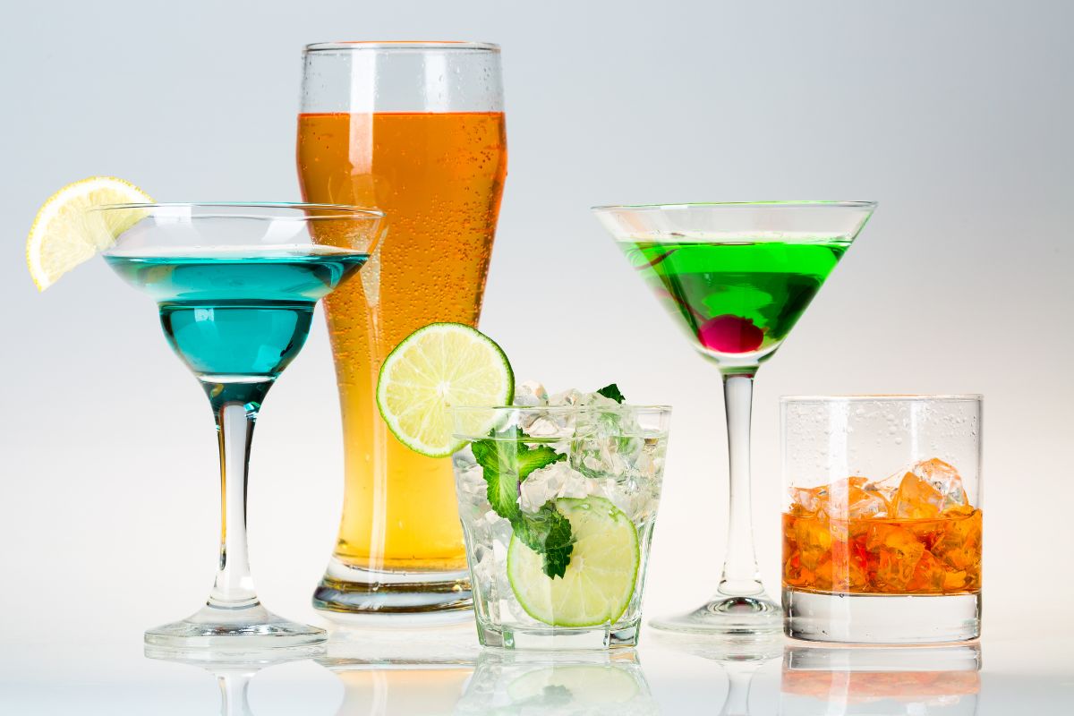 The picture shows glasses with drinks and fruits which refers to cutting back on alcohol and expensive drinks can save a surprising amount each month and more money in your wallet.