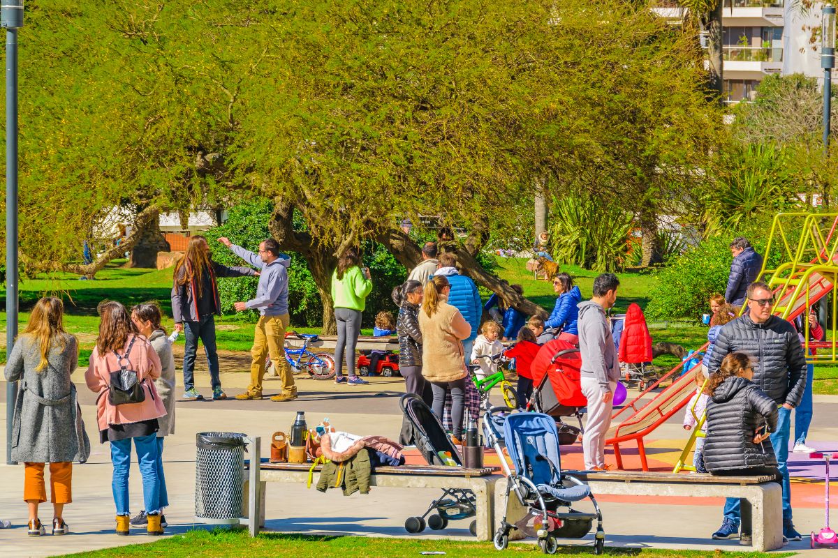 The picture tells about a group of people enjoying the park with their family and friends which means that using free entertainment options can save money per month.