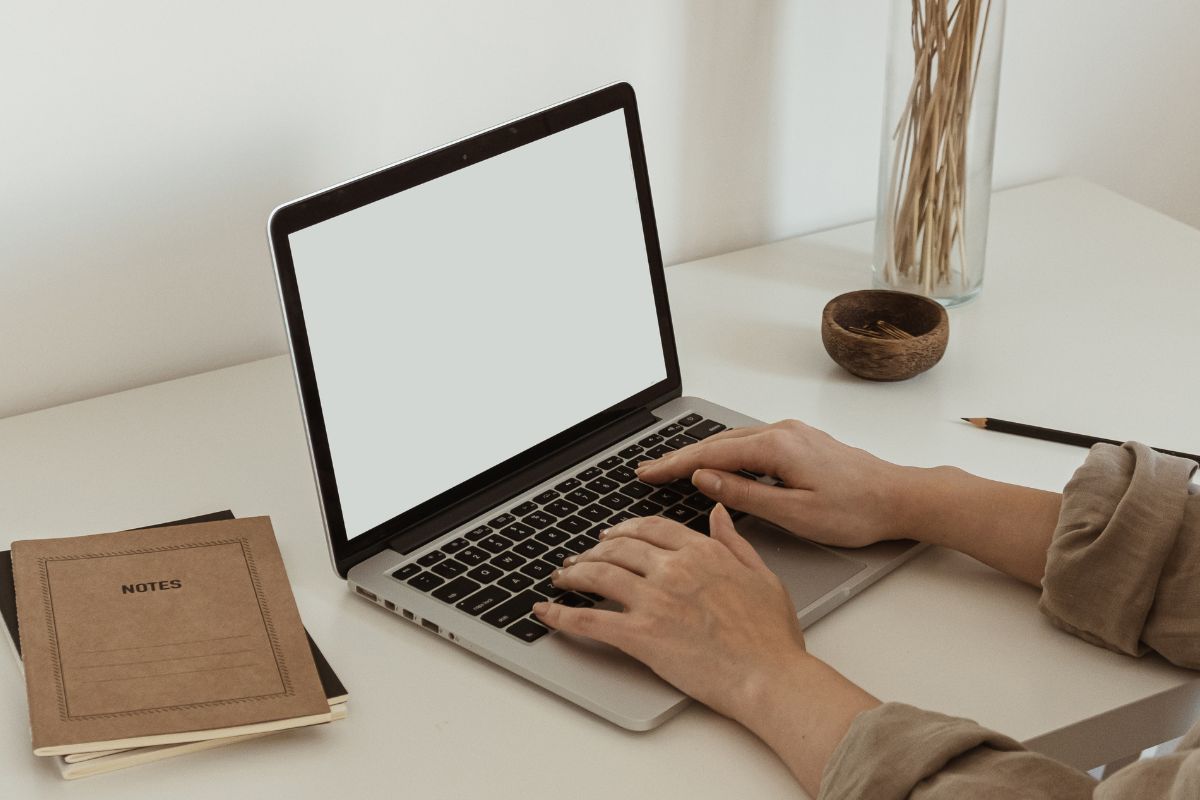 The picture shows a woman using a laptop.
