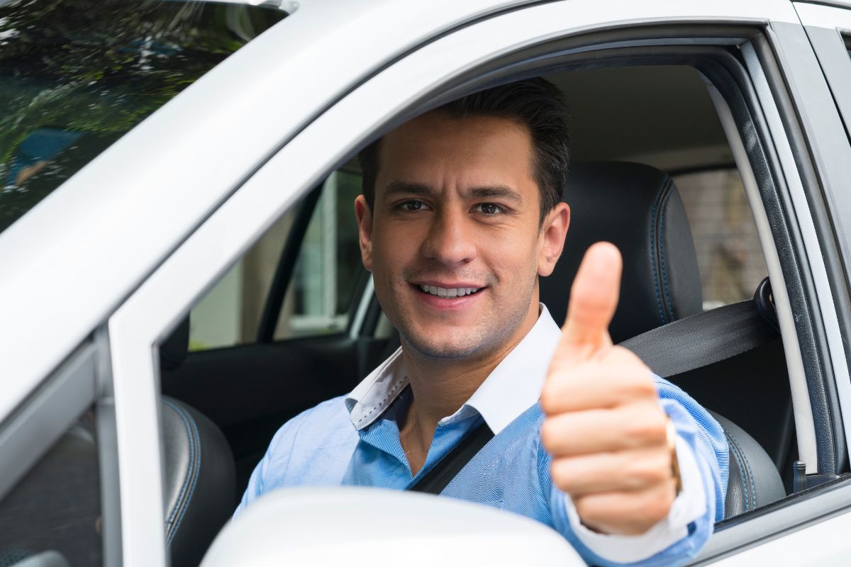 The picture of a man driving an Uber car.