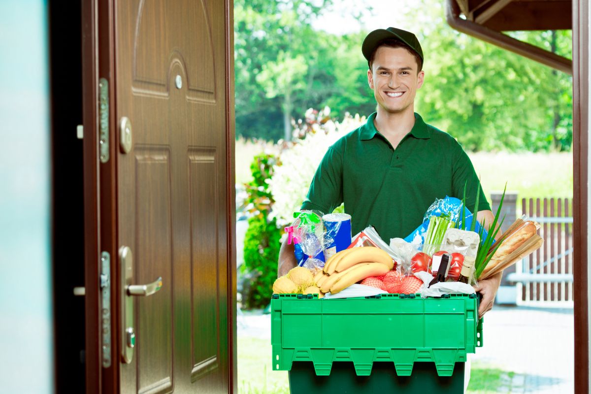 The image of a man working as a grocery deliveryman.