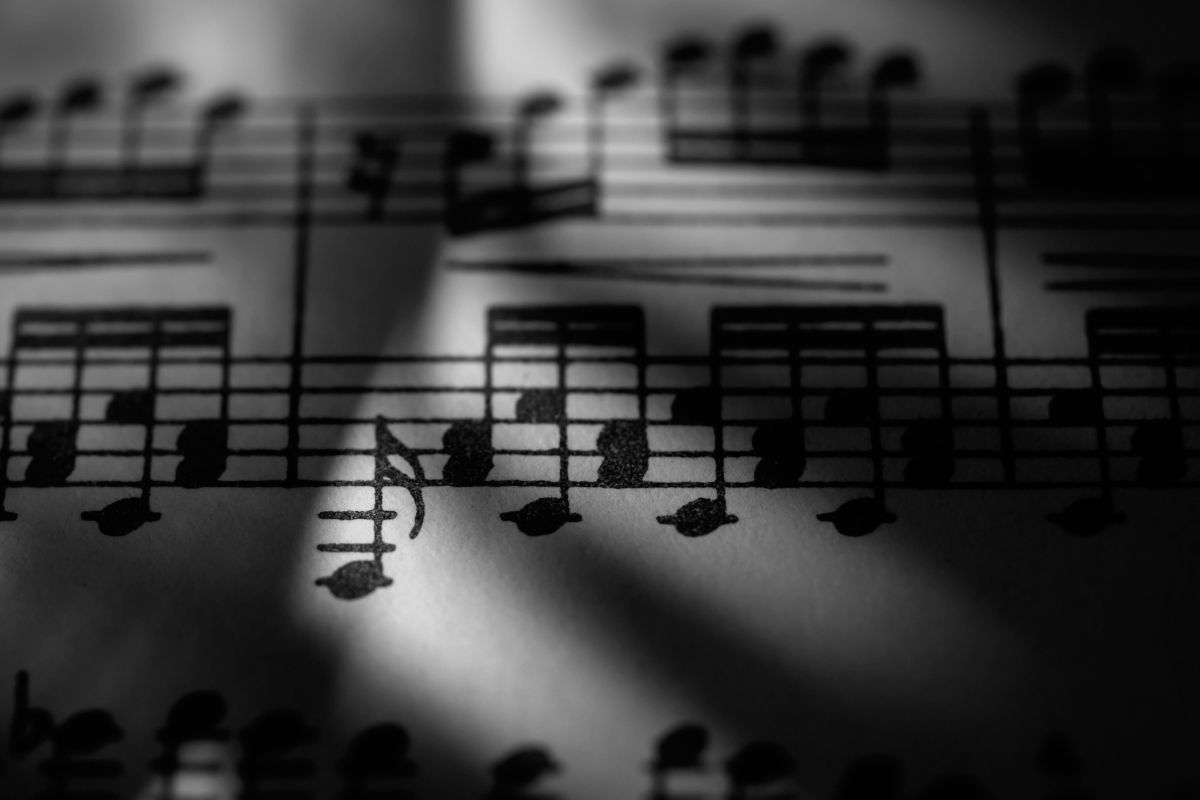 The picture shows a piece of paper with music notes referring to license music can bring in a steady income and a good way to make money without constant effort.