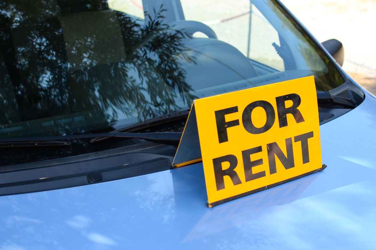 The picture tells about a car and a yellow signage indicating that renting out your car when not in use makes it easier to handle surprise expenses later.