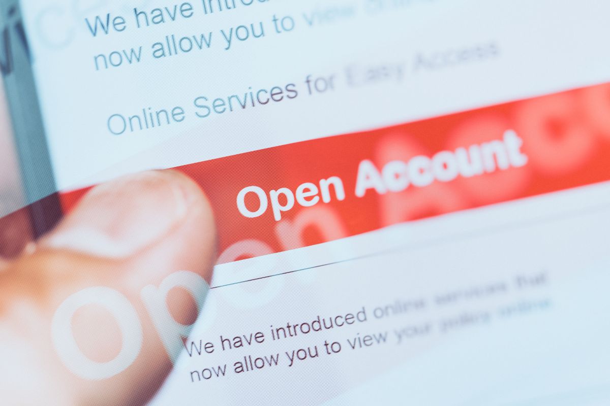 The picture shows a man's hand opening an account.