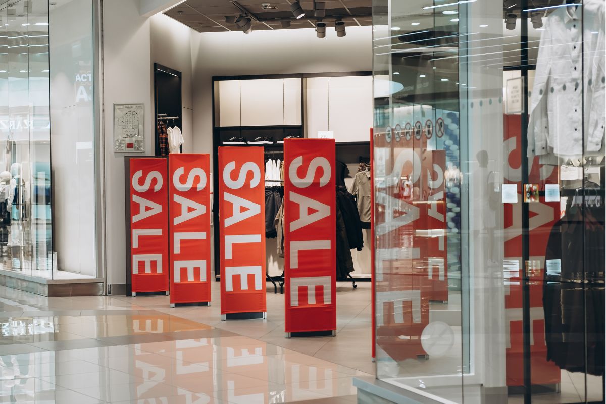 The image tells about a torn with red signage which means avoiding temptations like sales is one of the best ways to stick to a no-year buy.