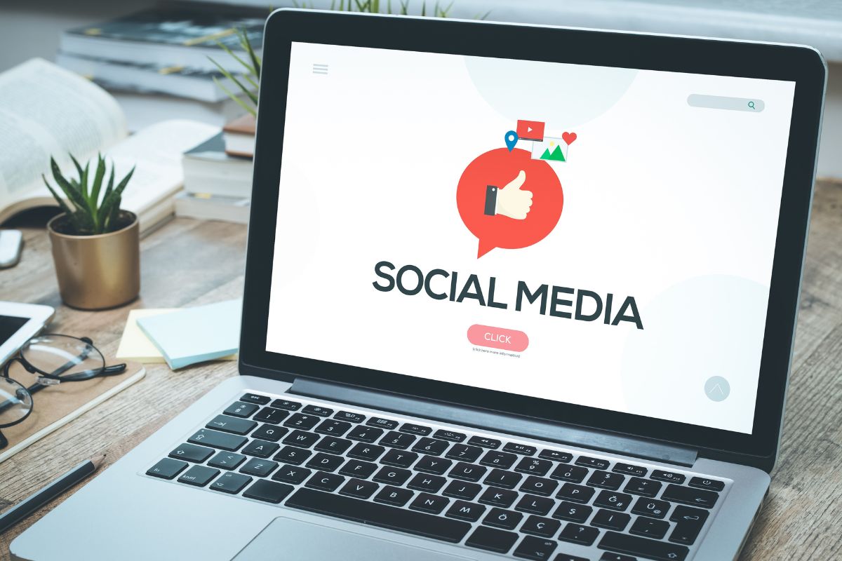 The photo shows a laptop with a social media display.