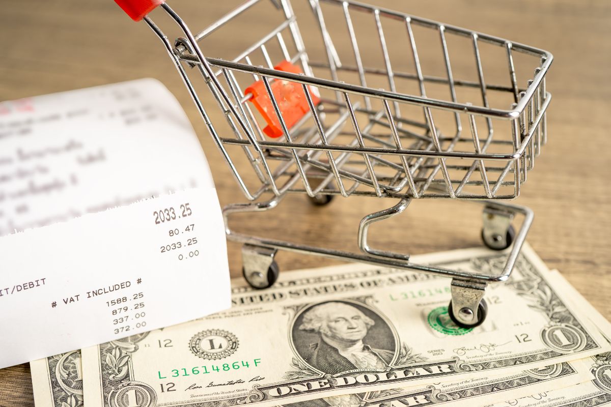 A photo of money, a receipt, and a cart.