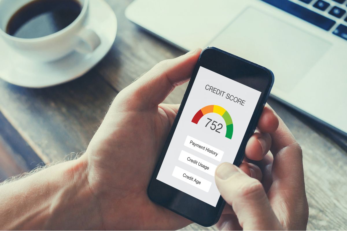A photo of a man's hand checking his credit score.