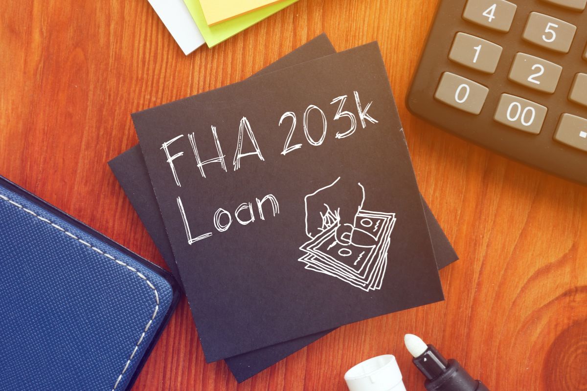 The photo tells about a calculator, a notebook, sticker notes, and black paper with notes referring to qualifying for any special refinancing programs that can make refinancing easier and more affordable.