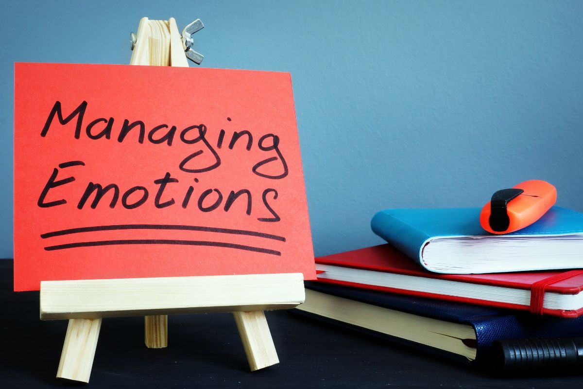 The picture of a paper with managing emotions wording.