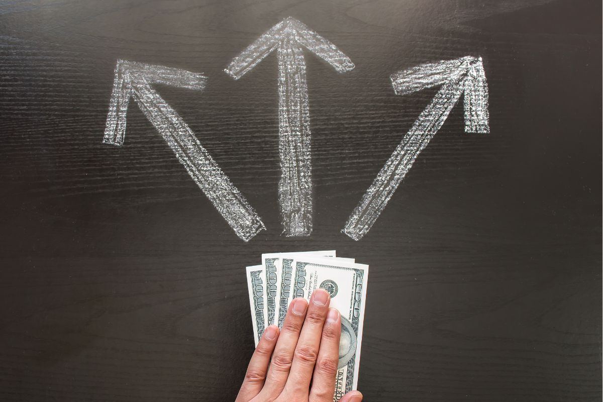 A photo of a woman's hand making financial decisions.