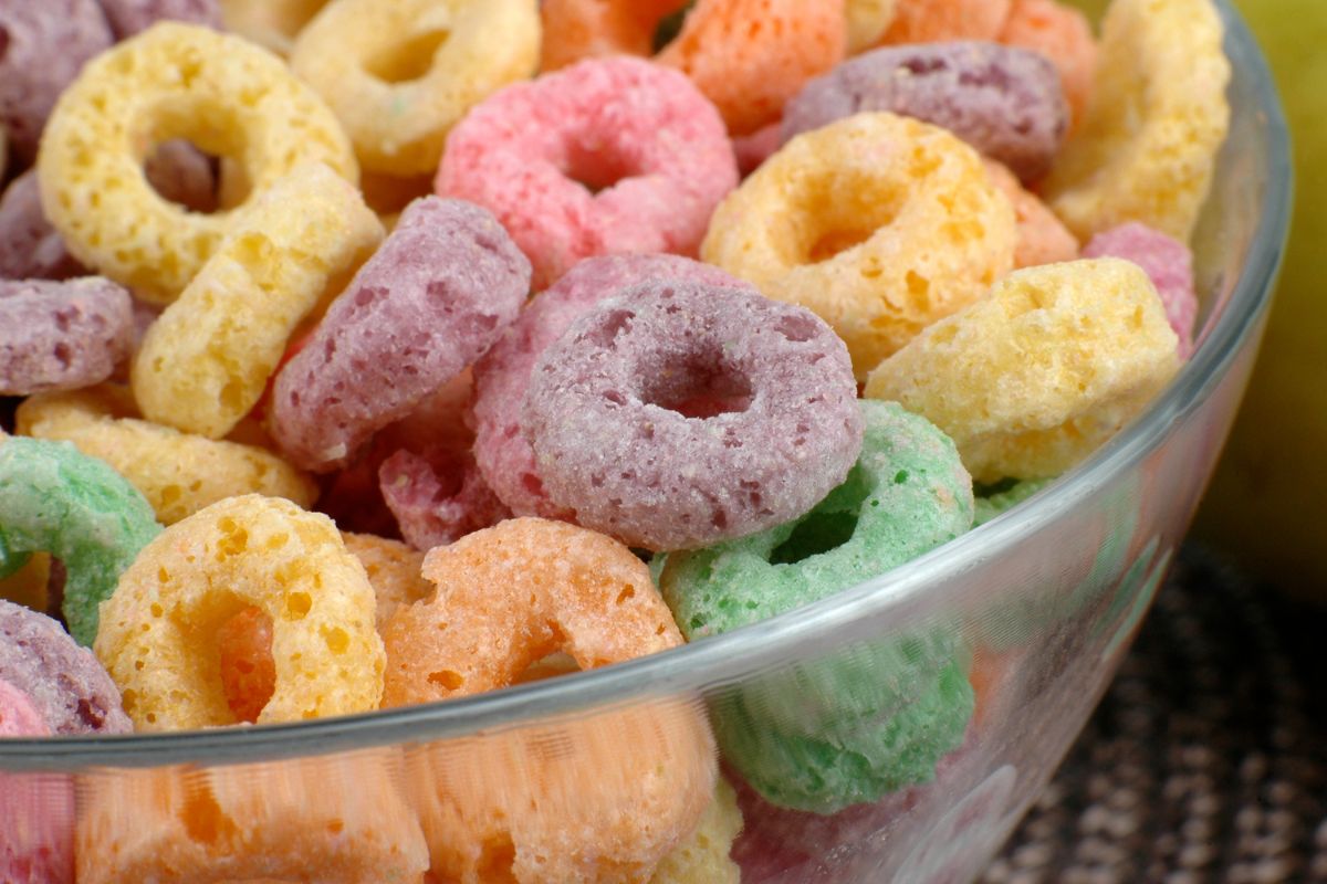 The image shows a bowl with sugary cereals inside is cost way more than basic oats or eggs.