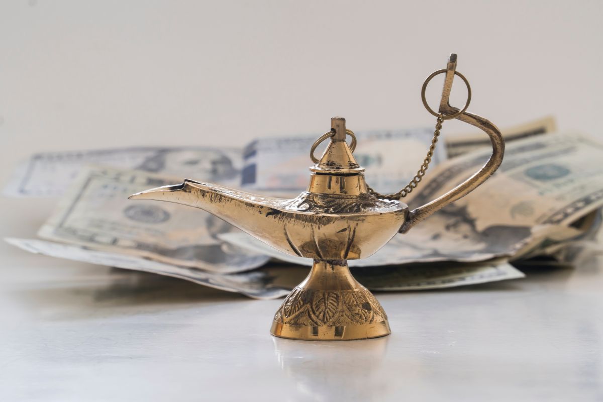 The picture of a metal kettle and dollar bills refers to learning how to manifest your money which can build long-term stability and independence.