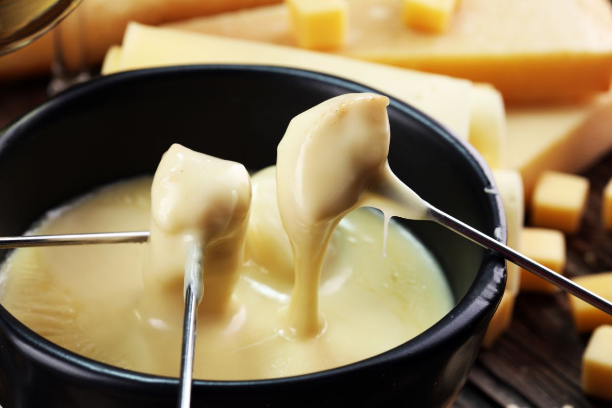 The picture shows foods inside the containers with disposable forks referring to single-serve packaged foods cost way more than buying in bulk, buying in larger sizes and portioning at home keeps costs down.