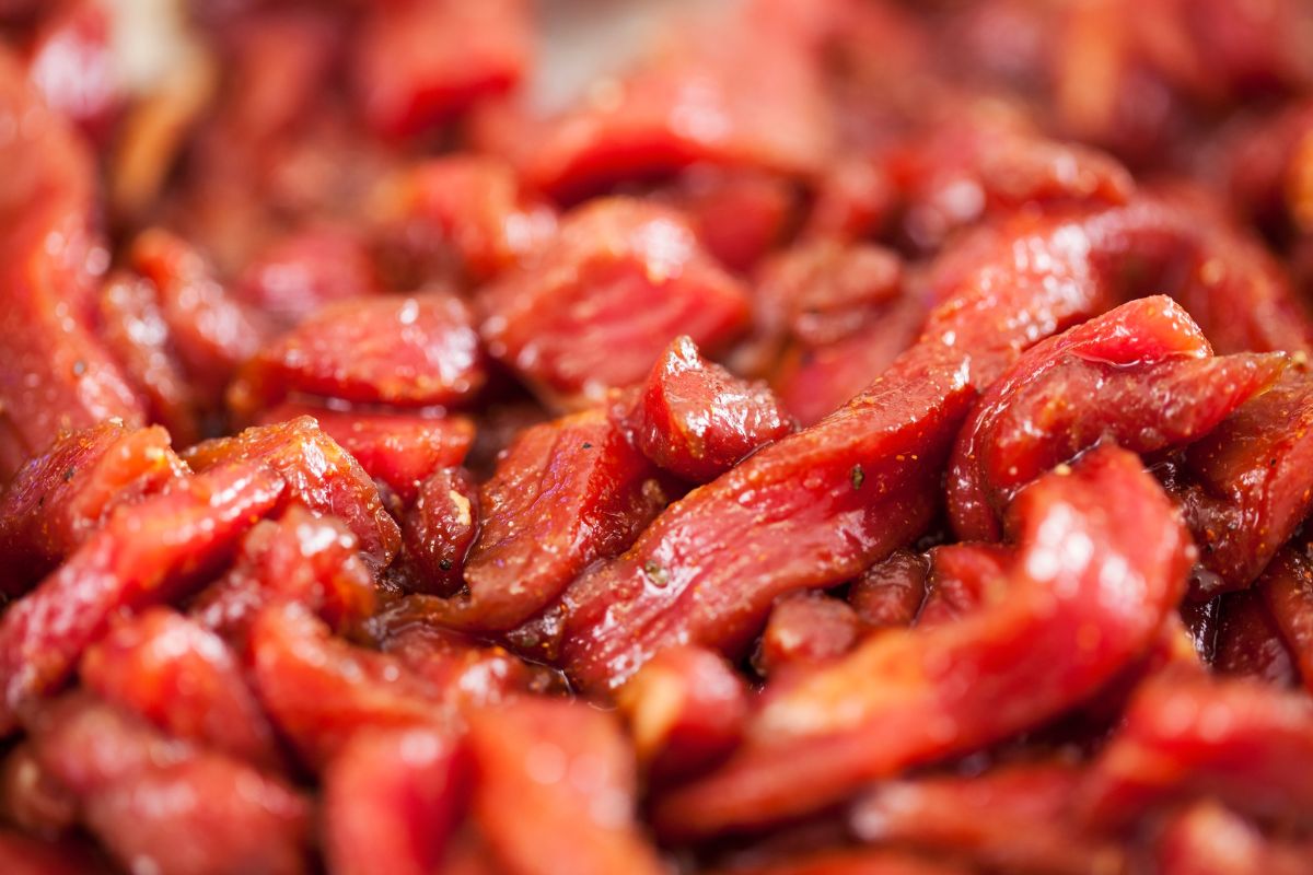 The image tells about pre-marinated meats, which are often overpriced and filled with extra preservatives, making simple marinades with pantry staples save money.