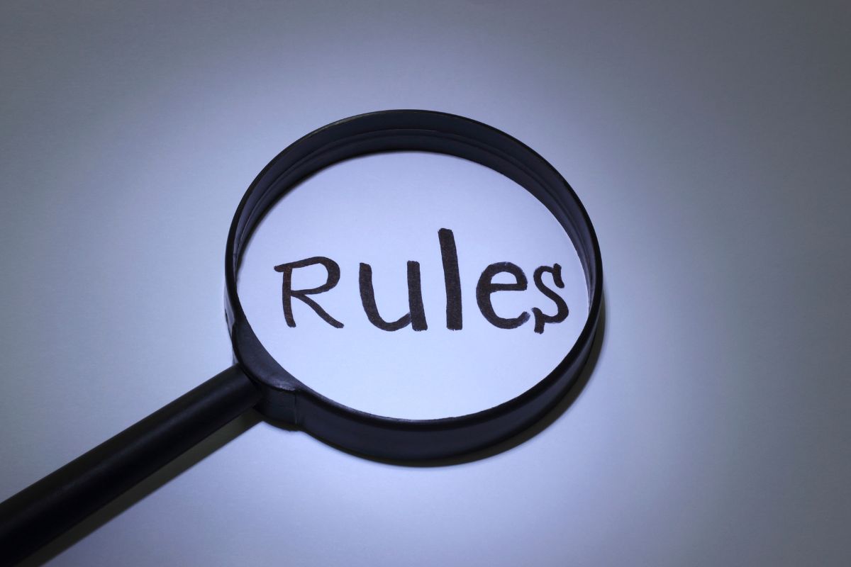 The image shows a magnifying glass with a note referring to clear rules and commitments that can make it through.