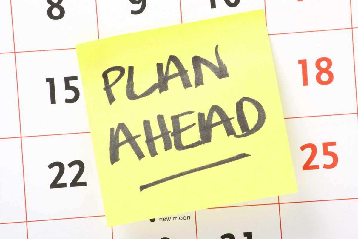 The picture of a calendar and paper with plan ahead wording.