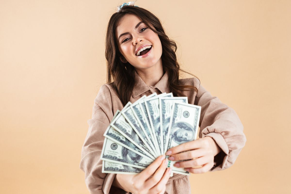 Photo of a woman showing dollar bills.