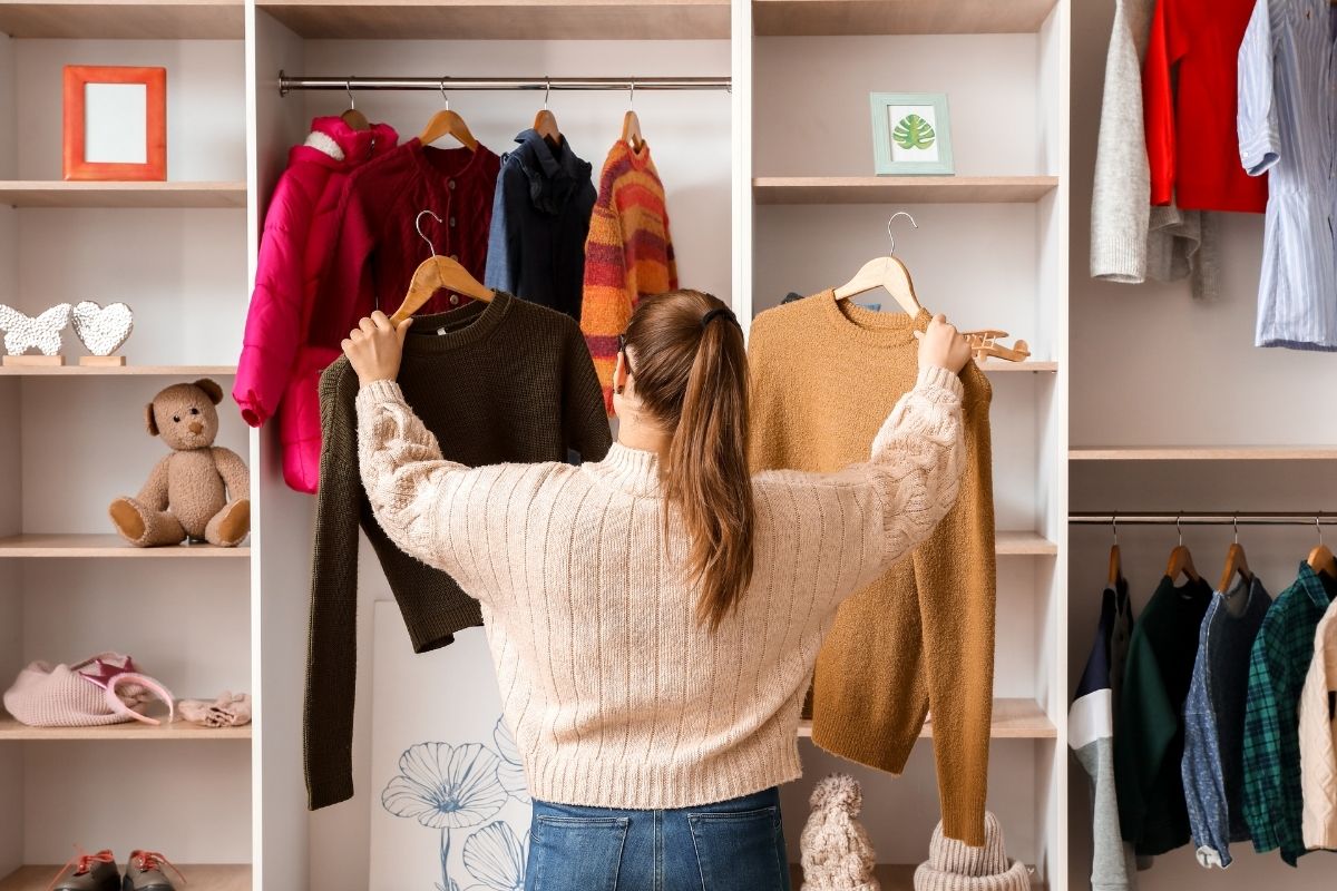An image of a woman choosing what to wear.