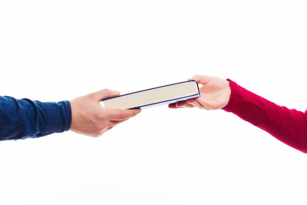 The photo shows the borrowing of a book.