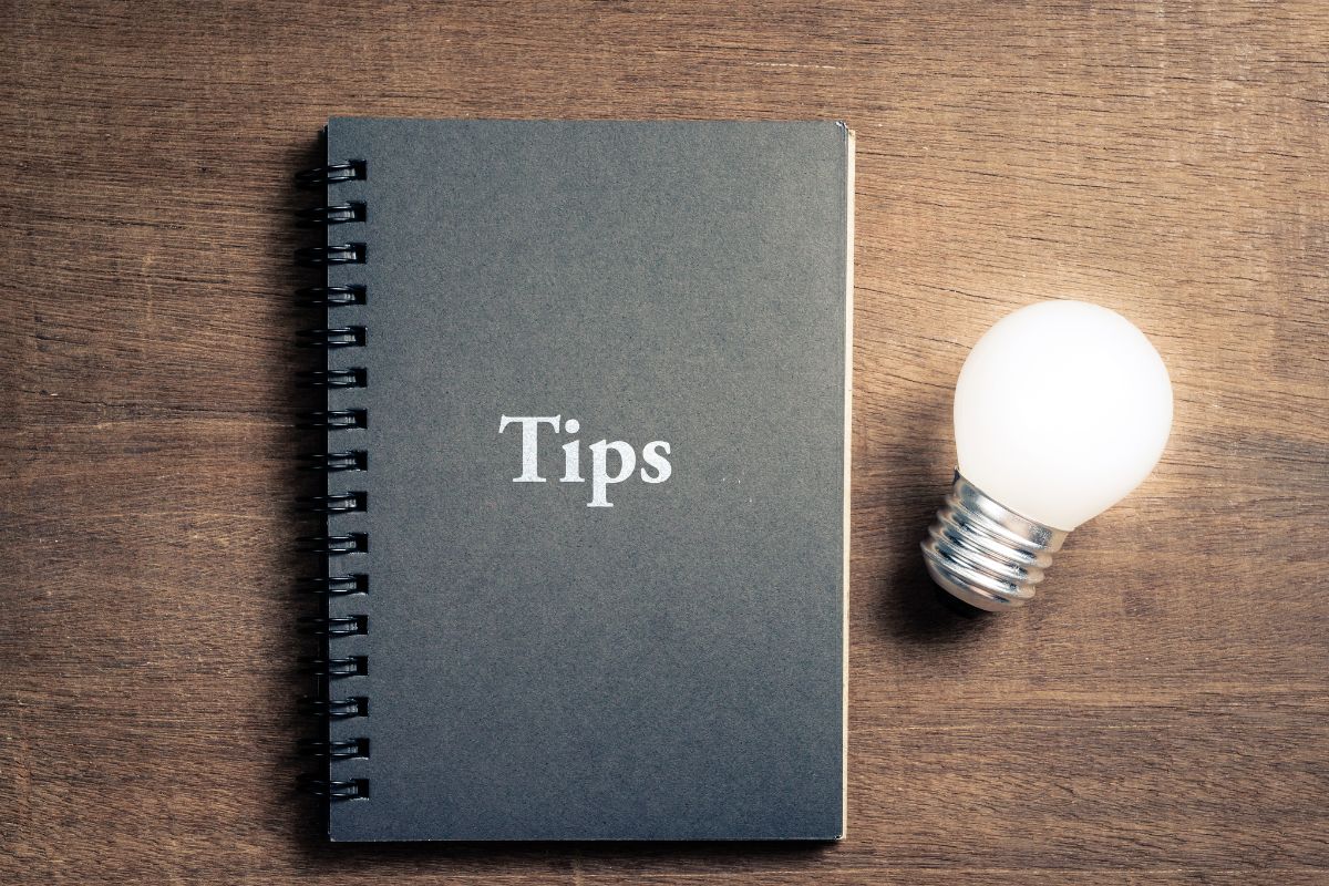 The photo of a bulb and a notebook with tips.