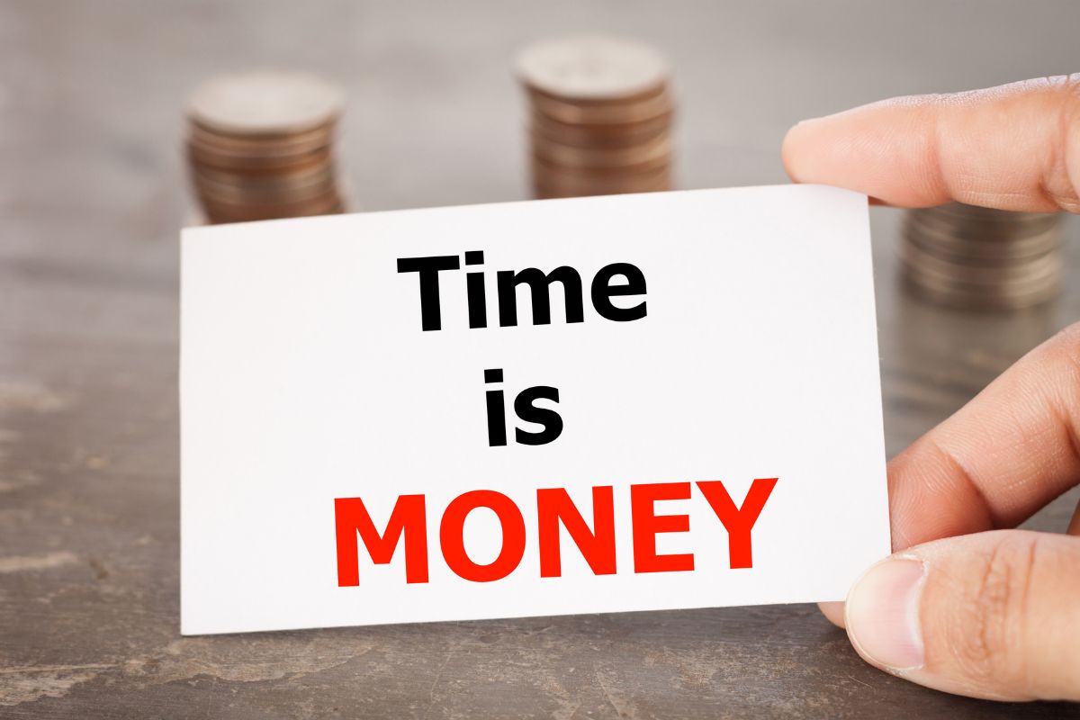 The image of coin stocks and a man's hand holding a piece of paper with notes which refers to repeating these money mantras can help shift your mindset and enable you to manage money wisely.