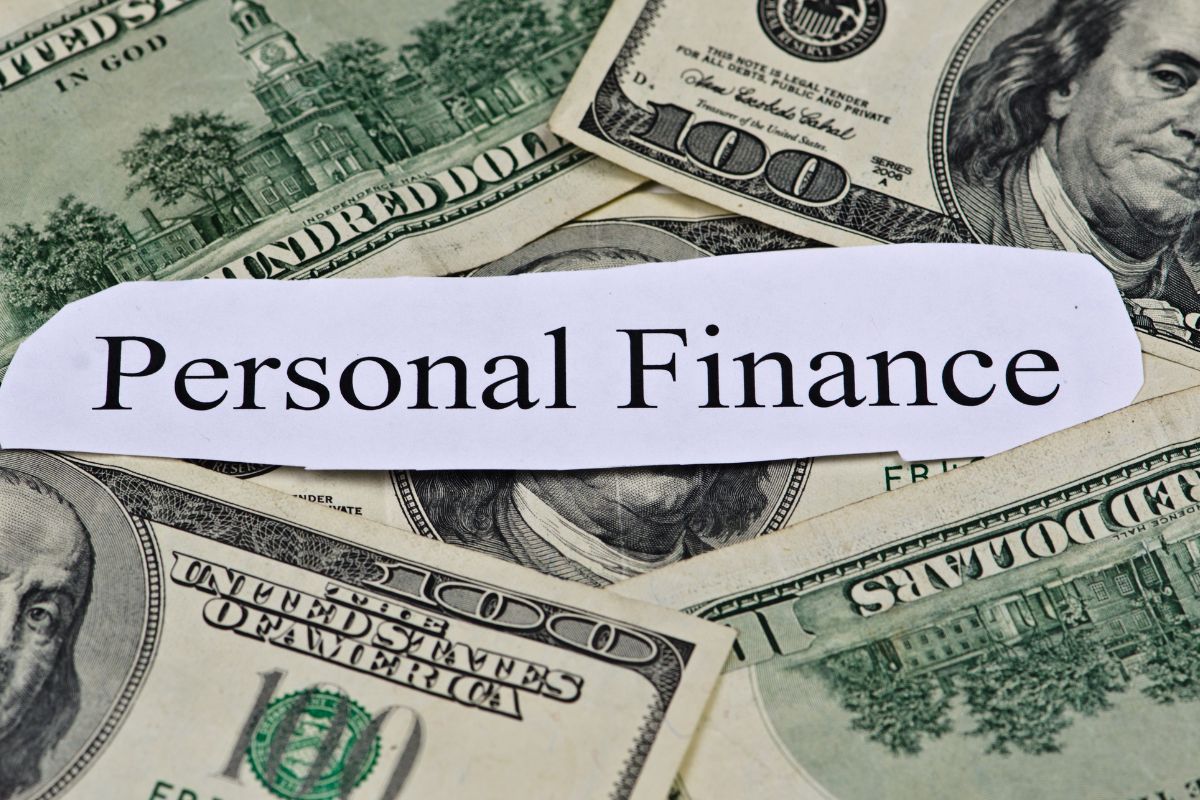 The picture of dollar bills and a piece of paper with notes indicating to educate yourself on personal finance helps you avoid costly mistakes.