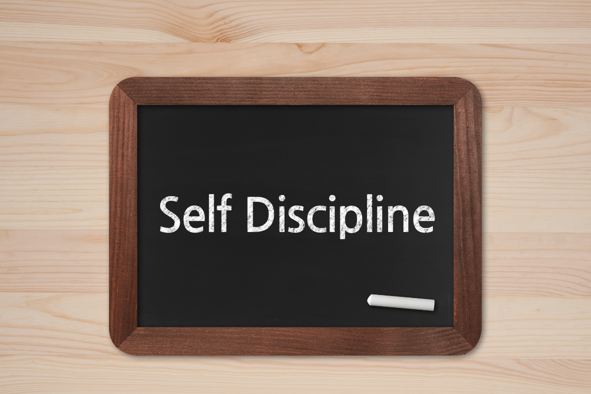 A picture of a board with self-discipline wording.