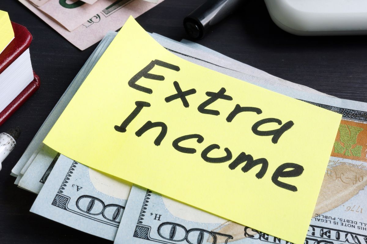 Image of money and paper with extra income wording.