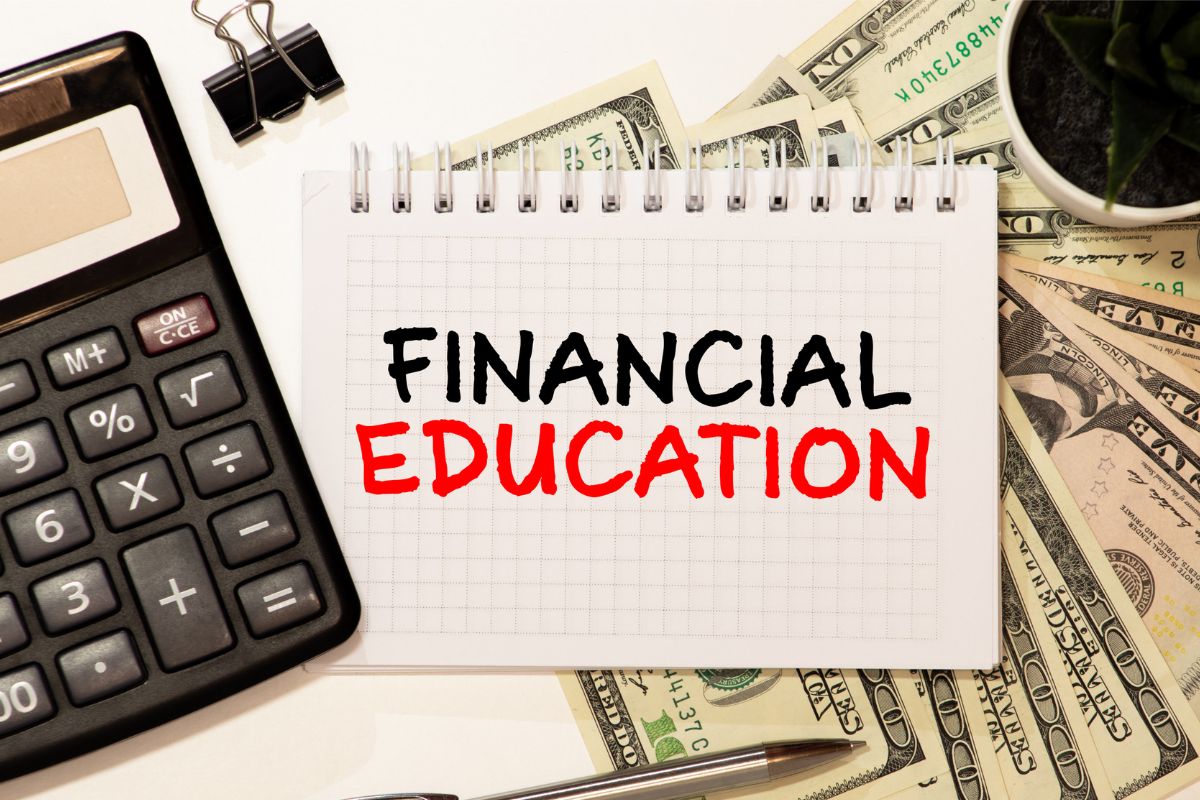Image of money and paper with financial education wording.
