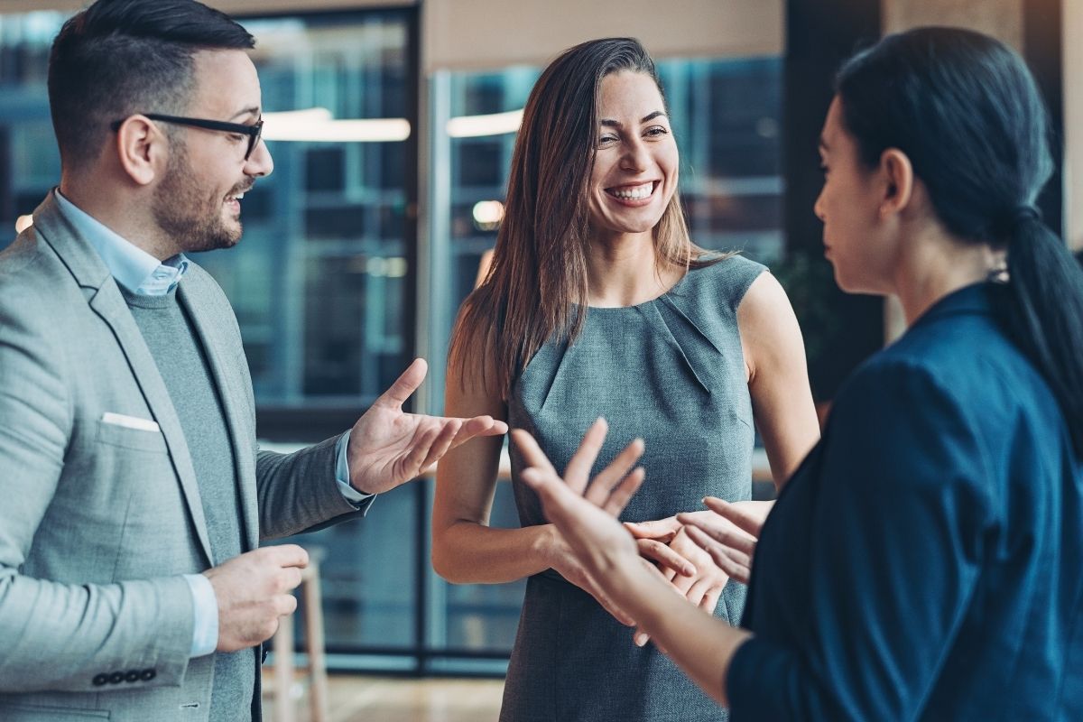 The picture shows a group of people having a conversation.