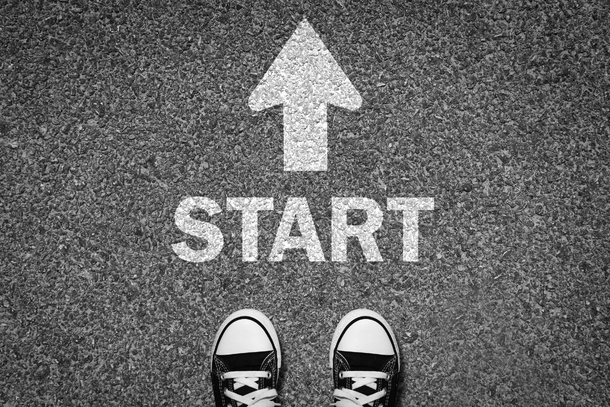 The image of a foot and the start wording on the road.