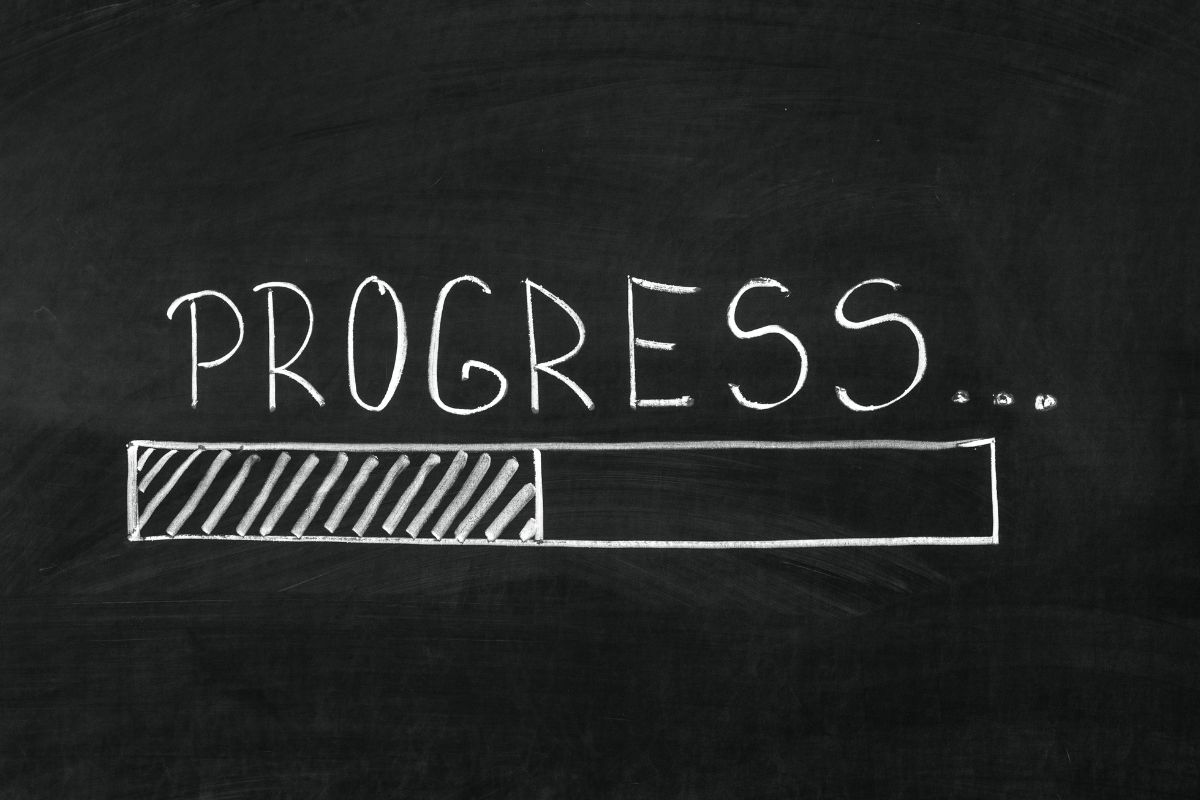 The photo shows a blackboard with a note and an illustration which means tracking your progress makes it easier to see the impact of your no-spend challenge.