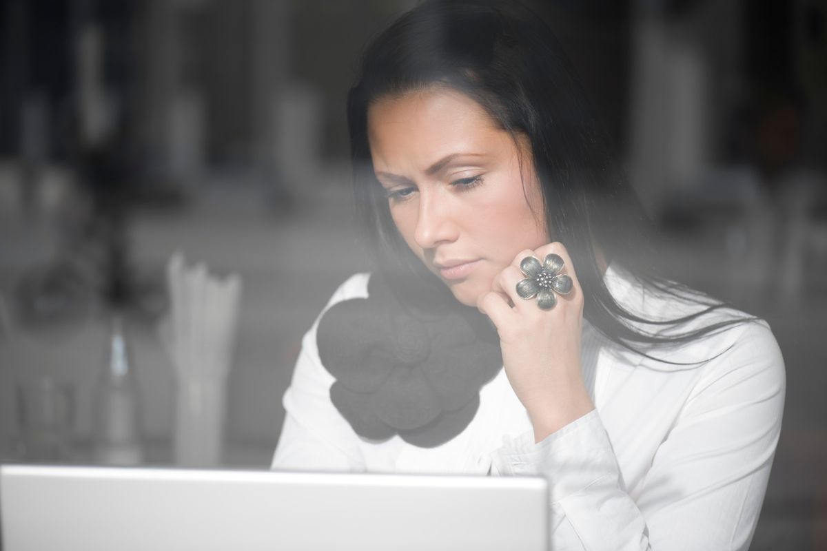 The photo of a girl using a laptop referring to reflect and adjust is a great way to reset and make smarter choices with your money.