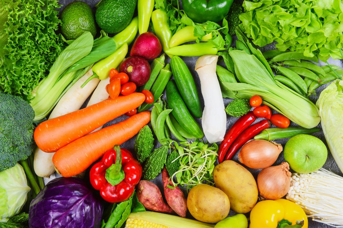 The image shows different kinds of vegetables referring to buying fresh produce in season for lower prices making it a better choice for budget shopping.