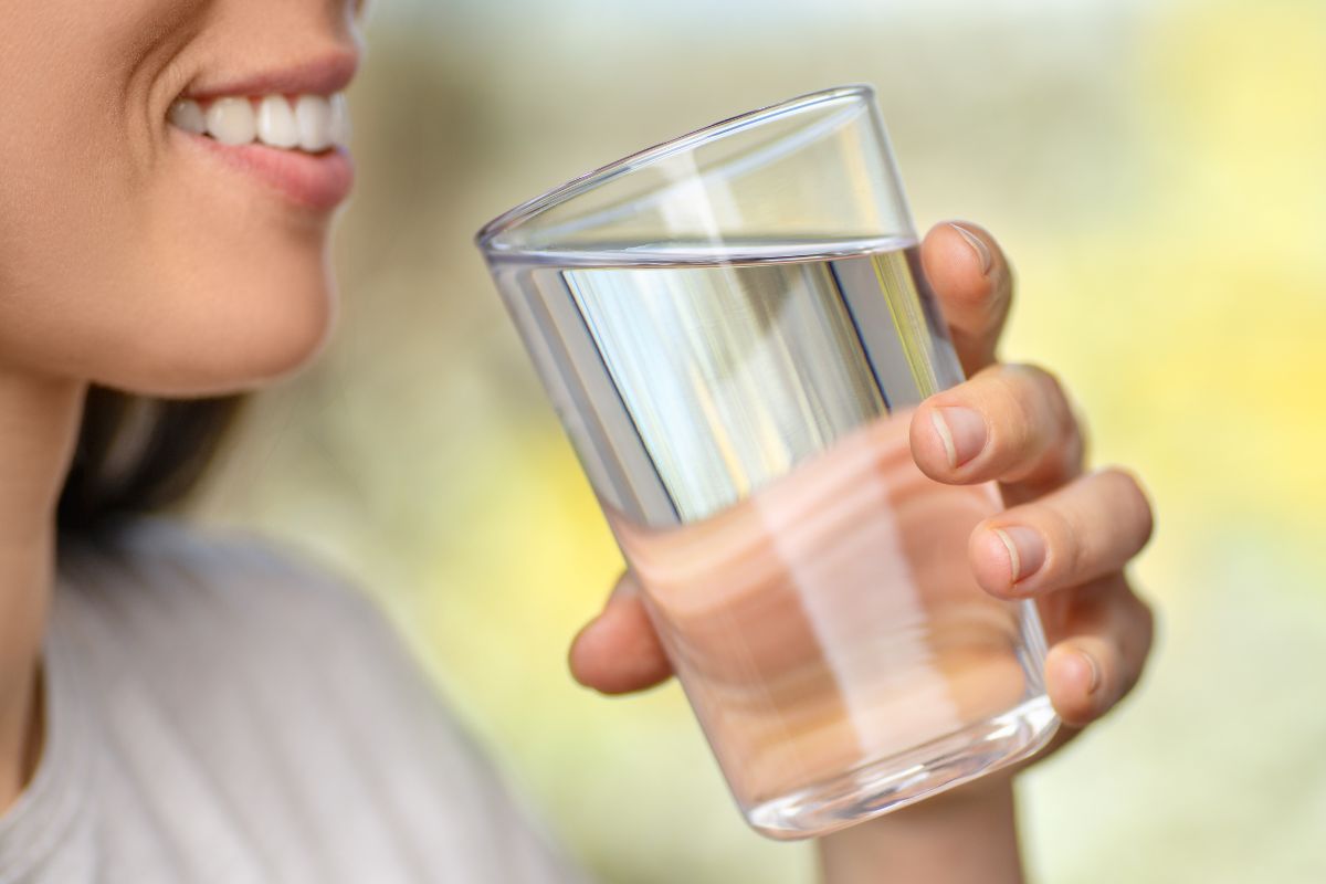 The picture shows a girl holding a glass of water which means drinking more water instead of buying sugar drinks keep both your wallet and your health in check.