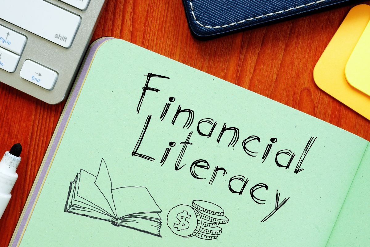 The picture of a notebook with financial literacy written.