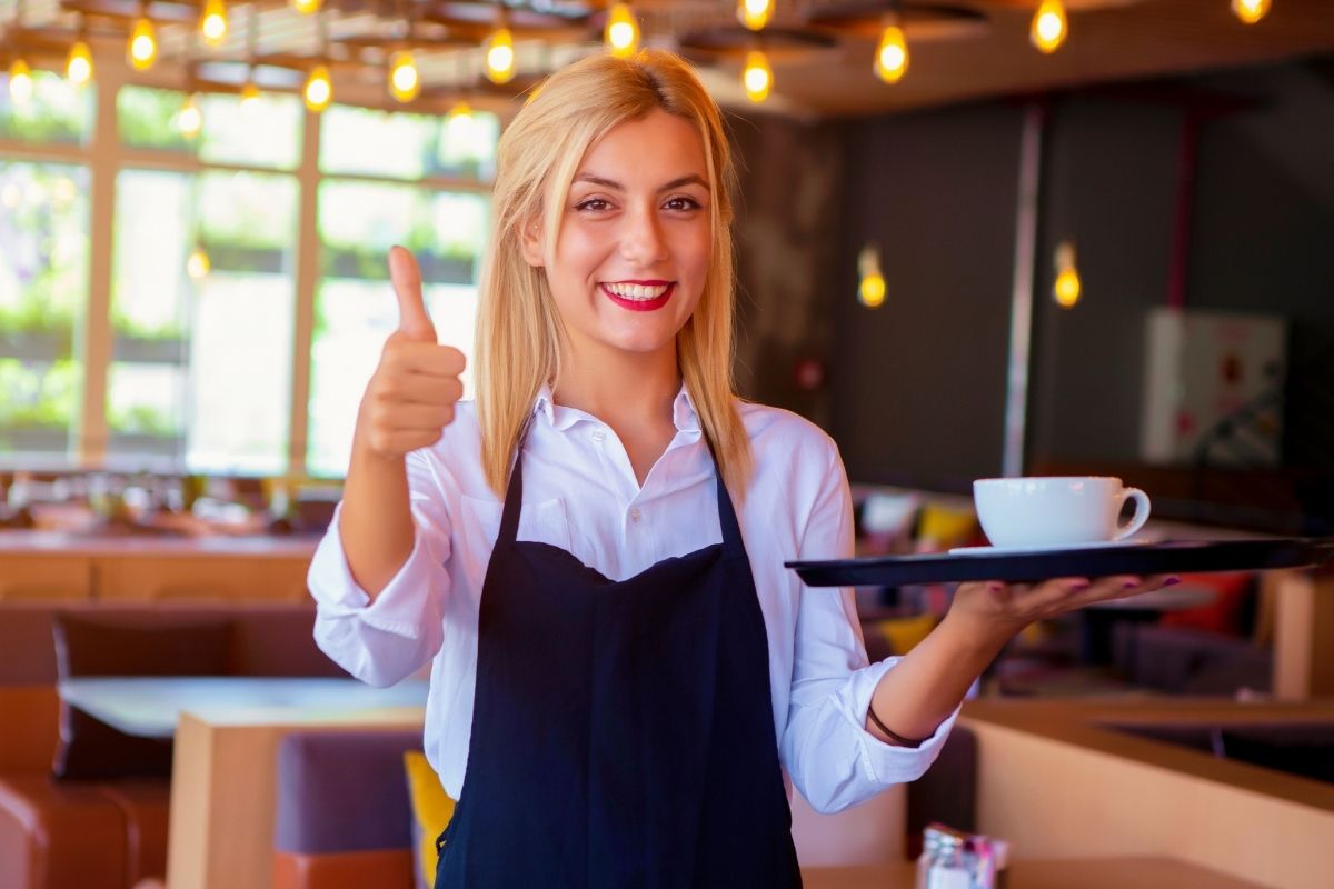 An image of a woman serving coffee.