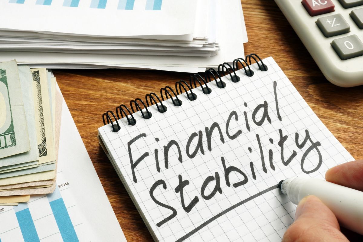 The photo shows a handwritten financial statement in a notebook.
